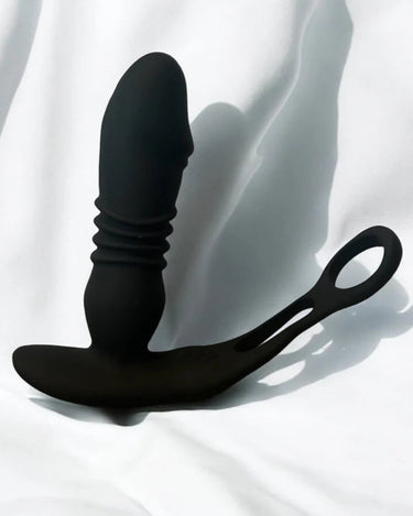 prostate massager sitting on top of a white sheet